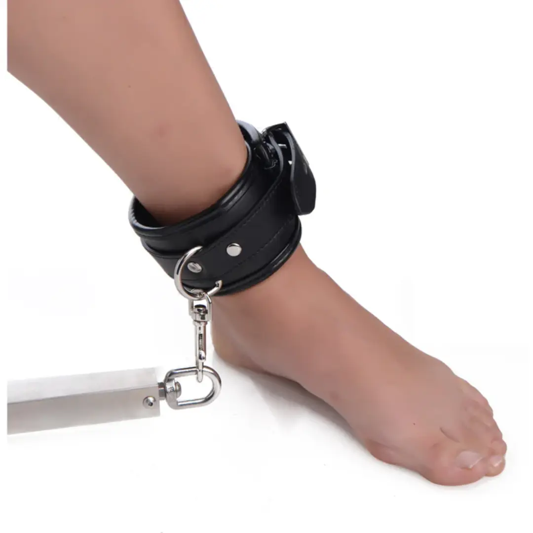 Black ankle cuff with metal bar attachment.