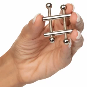 Hand holding a metal clamp jewelry device.