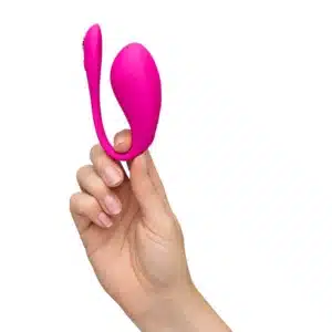 Pink personal massager held by hand