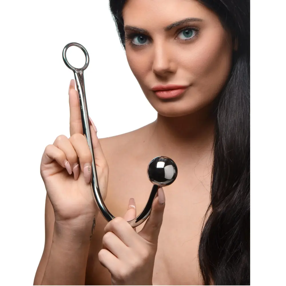 Woman holding a chrome hook with a ball end.