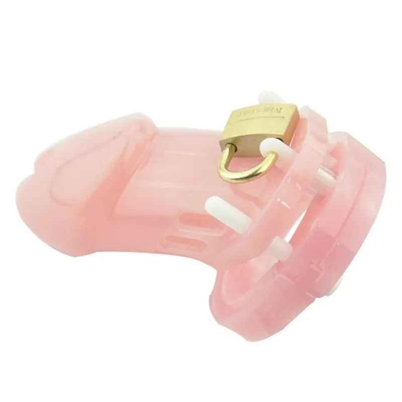 6000s short pink chastity cage with all included parts laid out against a white background