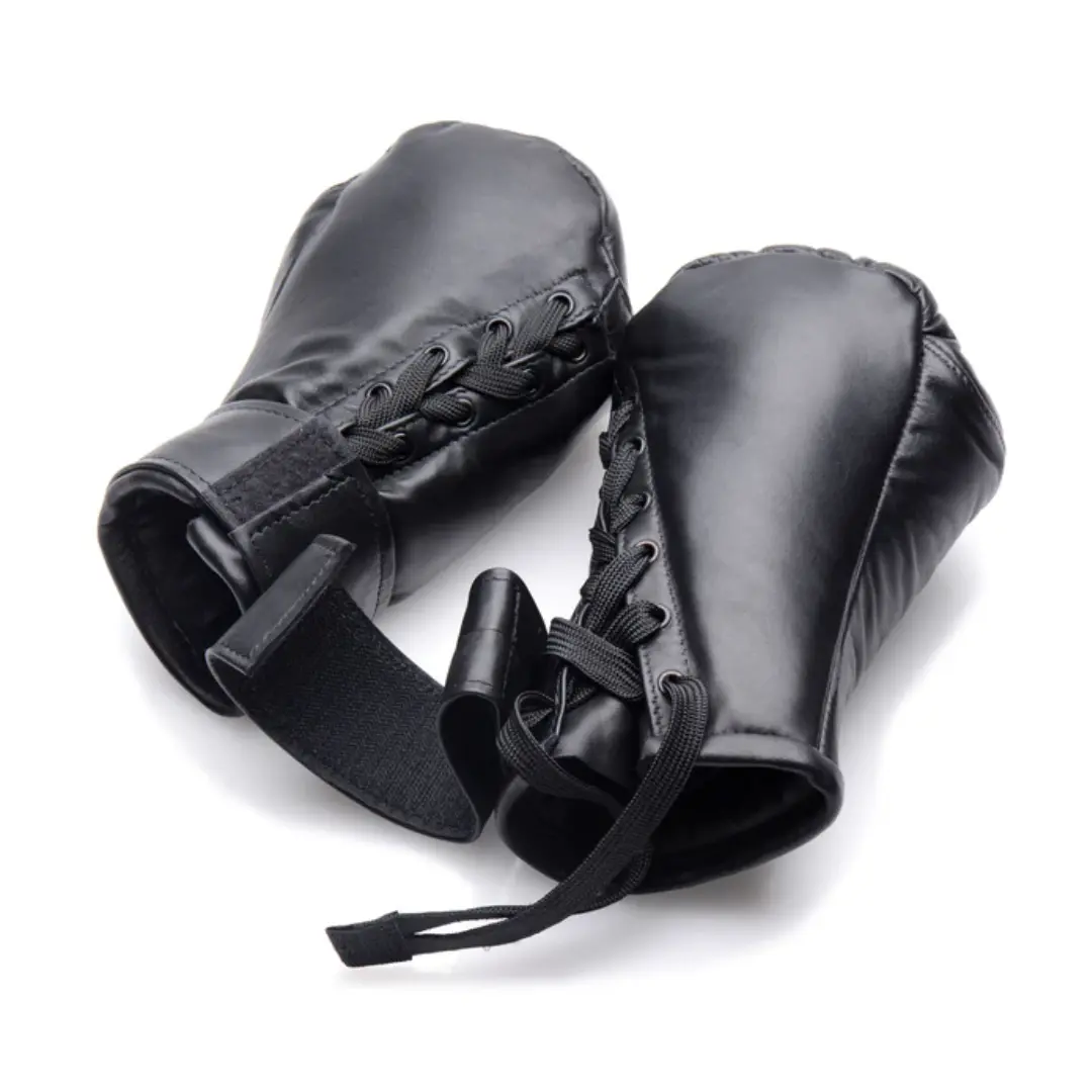 Pair of black boxing gloves with laces and straps.