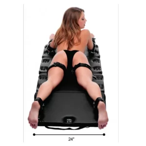 Inflatable bondage mat with restraints, 24 inches wide.