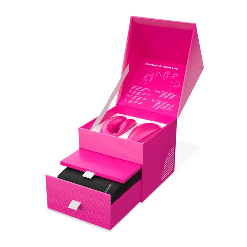 Pink gift box with interior compartments open.