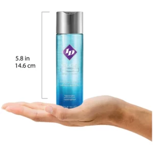 Hand holding ID water-based lubricant bottle.