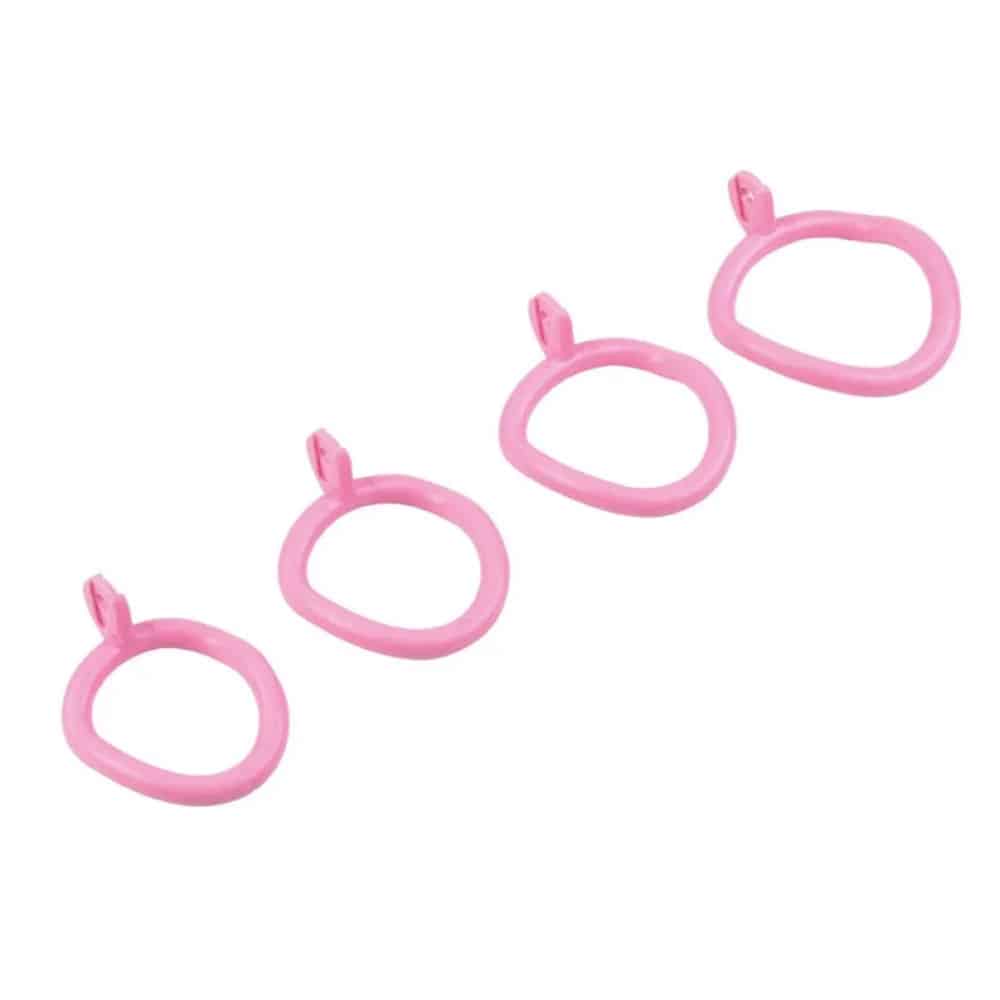 Four pink plastic hooks on white background.