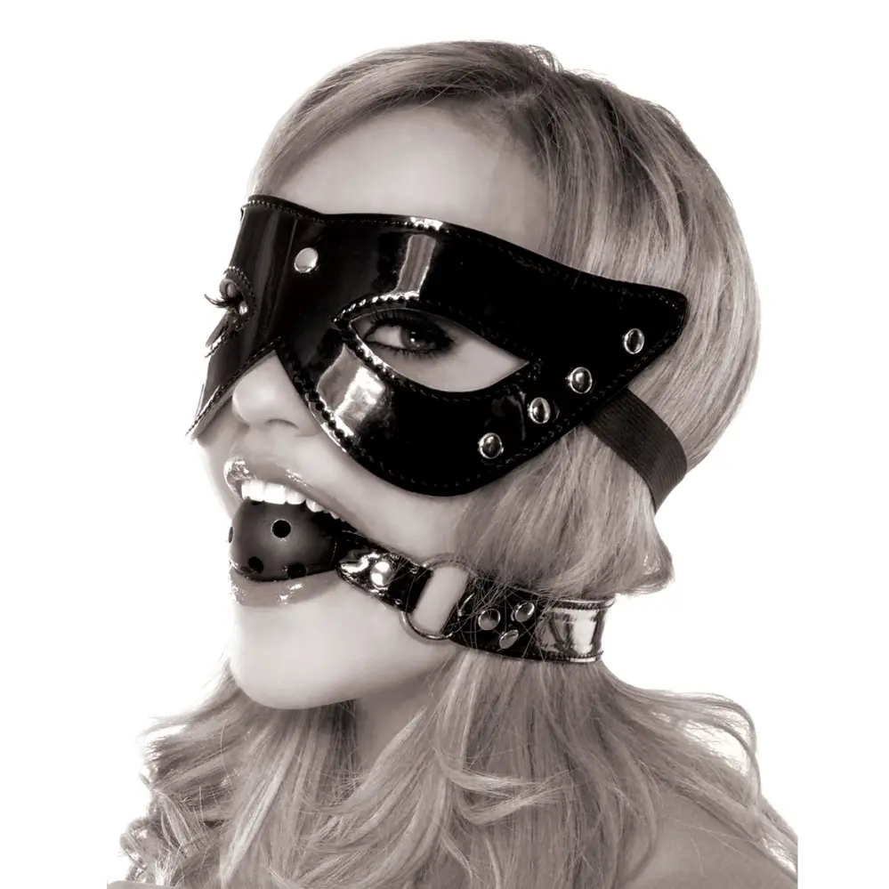 A woman wearing a black vinyl masquerade mask and a ball gag